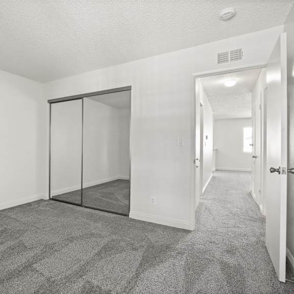 a room with a carpeted floor and a sliding door.