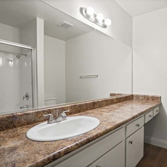 a bathroom with a sink and mirror.