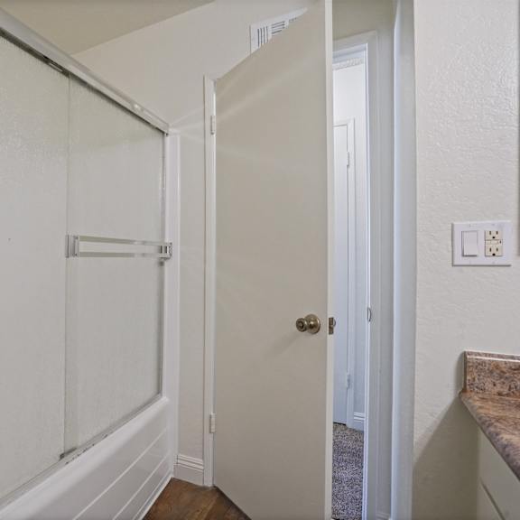 a white door is in a white hallway.