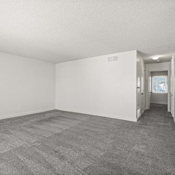 a room with a carpeted floor and white walls.
