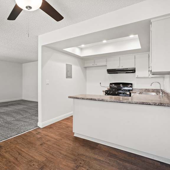 a kitchen area with a counter and a fan.