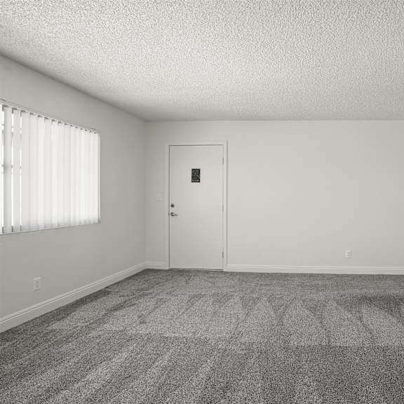 a room with a carpeted floor and a door.