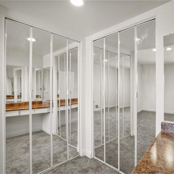 a room with a marble table and glass walls.