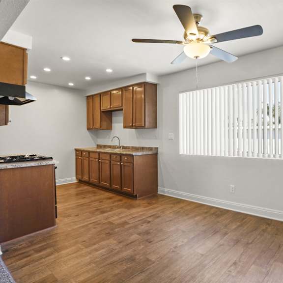 a room with wooden floors and a ceiling fan.