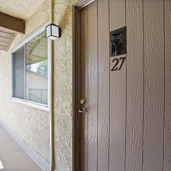 a brown door with the number 27 on it.
