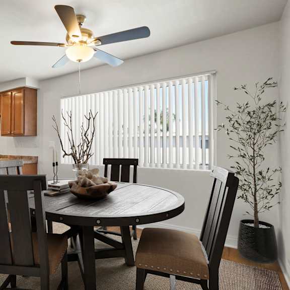 a dining room with a table and chairs.
