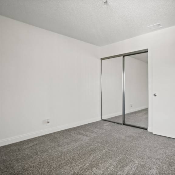 a room with a carpeted floor and a sliding door.
