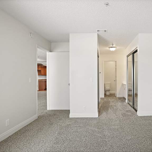 a white room with a carpeted floor and a white door.