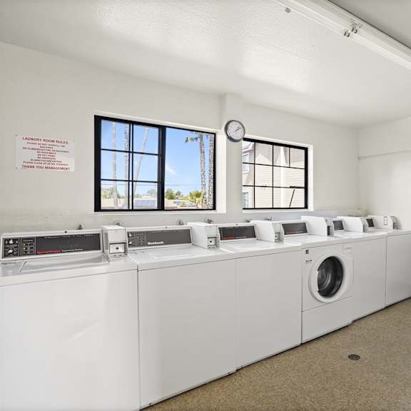 a laundry room with washers and dryers.