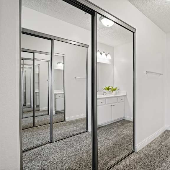 a bathroom with a toilet, sink, and mirror.