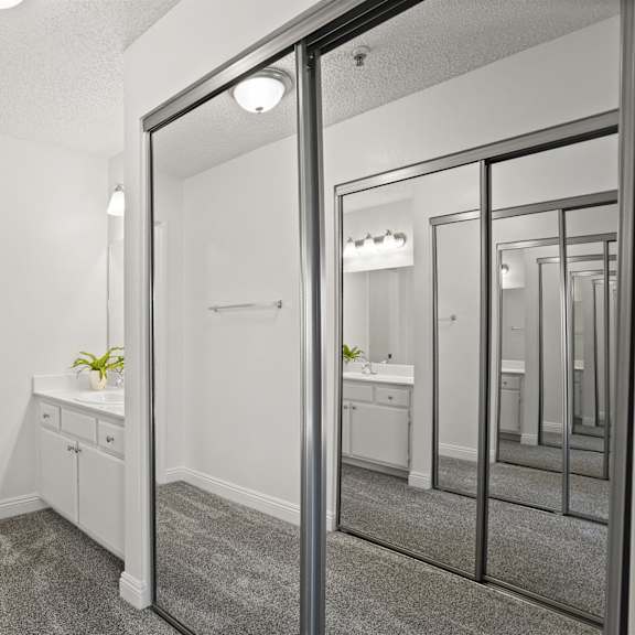 a bathroom with a toilet, sink, and mirror.
