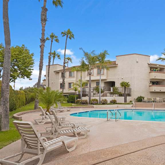 a large house with a pool in the backyard.