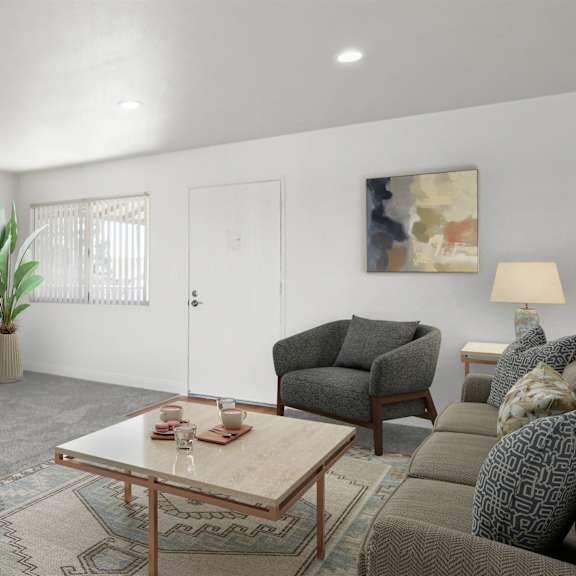 a living room with a grey couch, a wooden coffee table, and a rug.