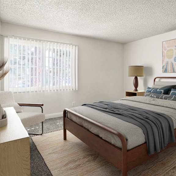 a bedroom with a bed, nightstand, and chair.