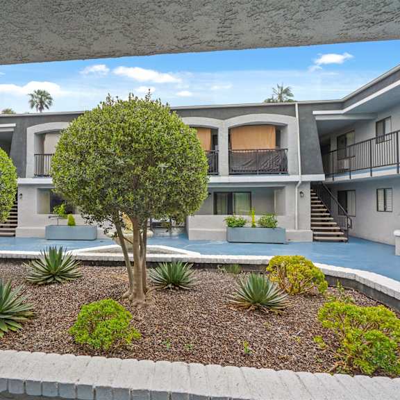 a modern house with a garden in the front yard.
