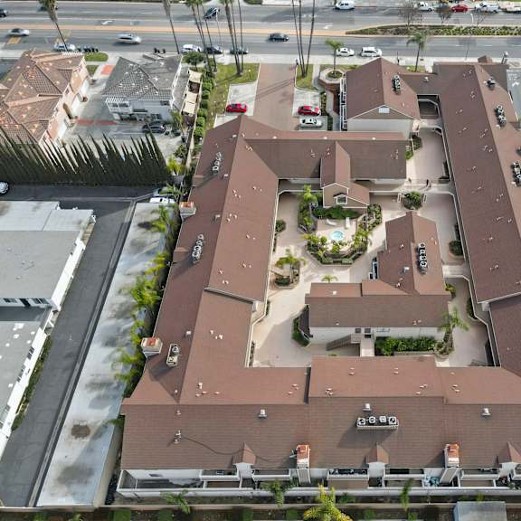 a large brown building with a courtyard in the middle.