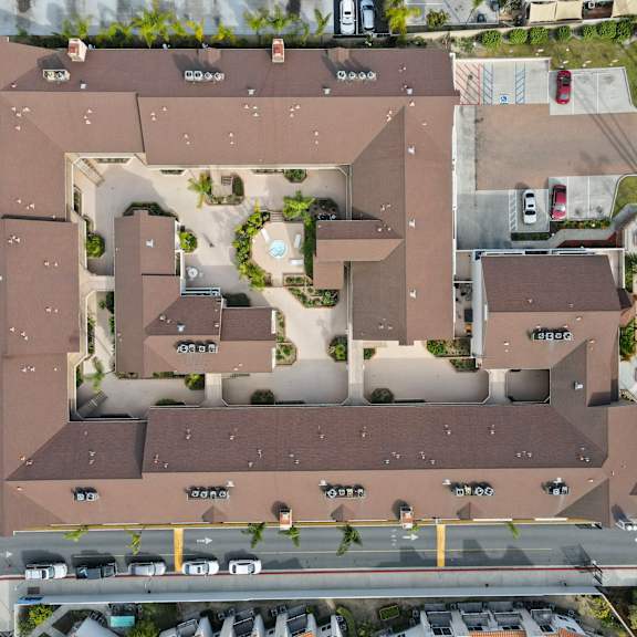 an aerial view of a residential complex with multiple buildings and roads.