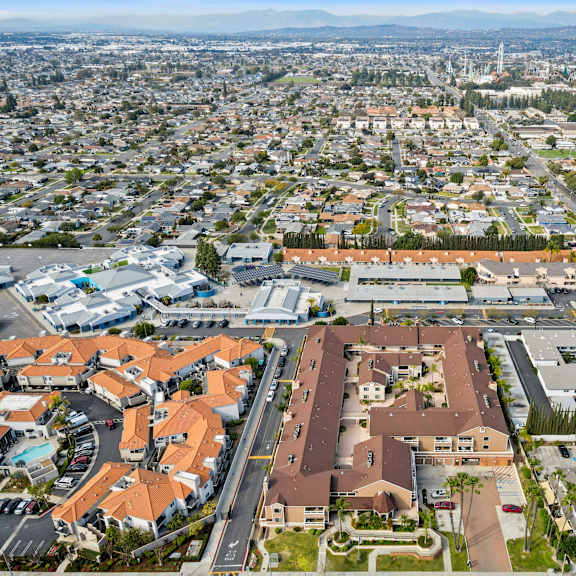 a bird's eye view of a city with a large building in the center.