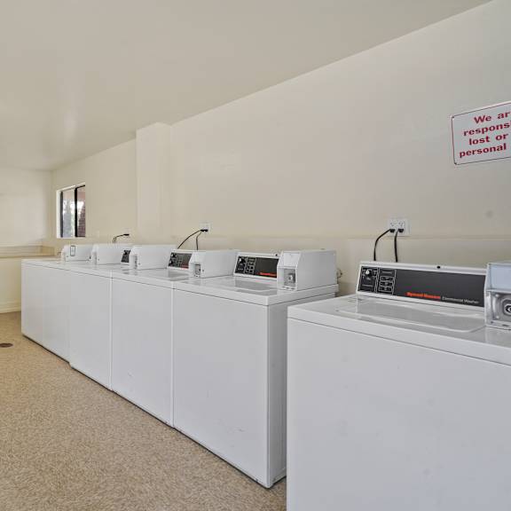 a laundry room with washers and dryers.