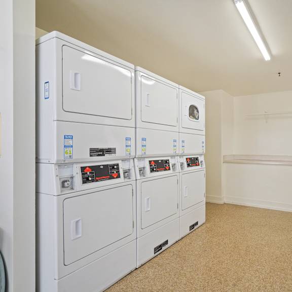 a row of white electrical boxes are lined up in a room.