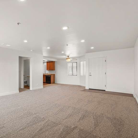 a large, empty room with a carpeted floor and white walls.