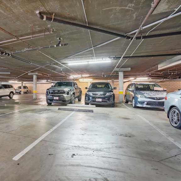 a parking garage with multiple cars parked.