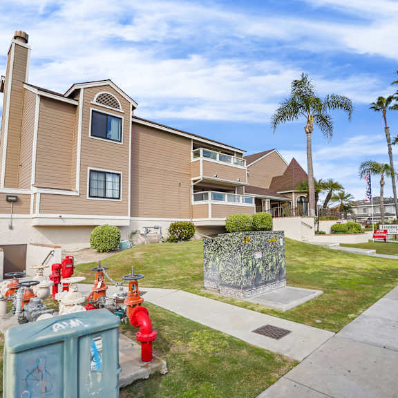 a residential building with a red fire hydrant in front of it.