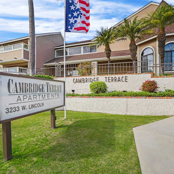 a sign for cambridge terrace apartments stands in front of a building.