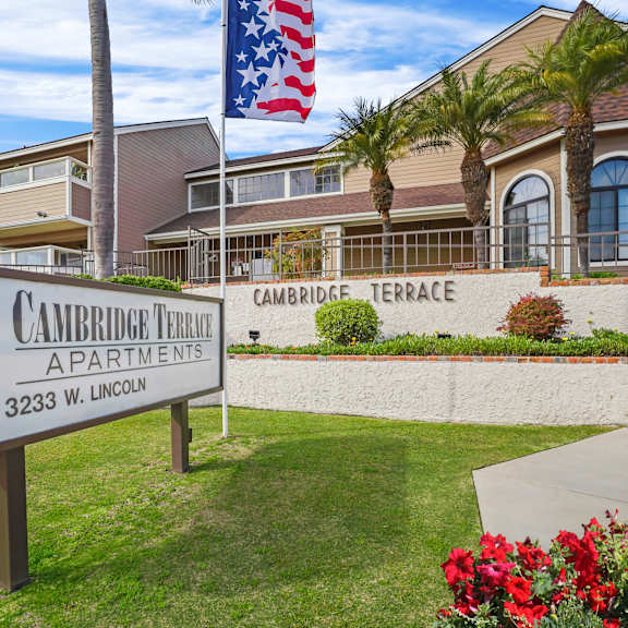 a sign for cambridge terrace apartments stands in front of a building.