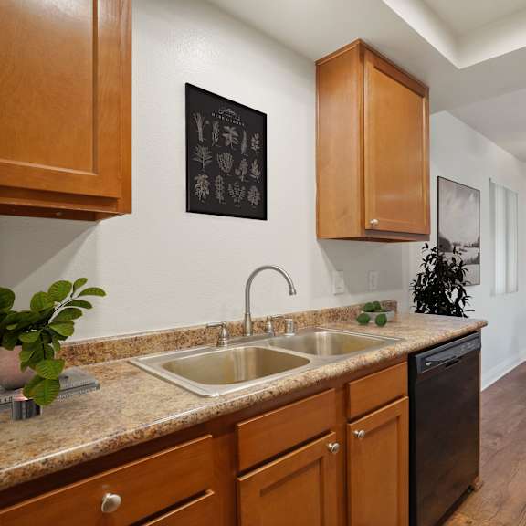 a kitchen with a sink and a fridge.