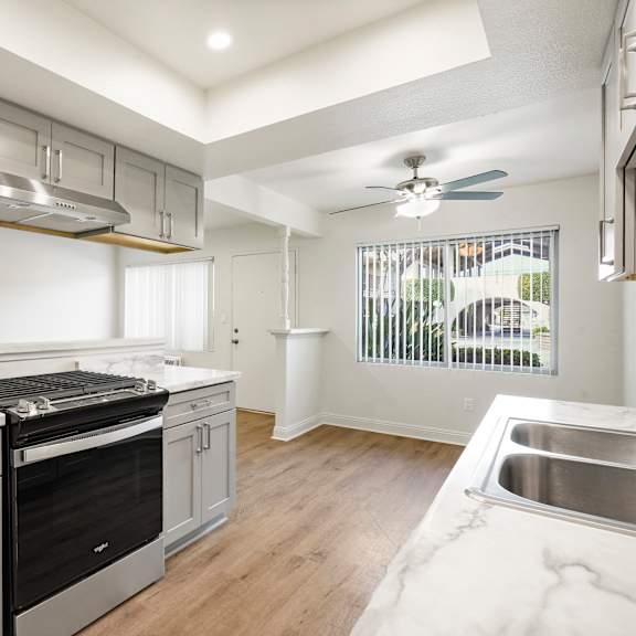 a modern kitchen with a stainless steel oven and a marble countertop.