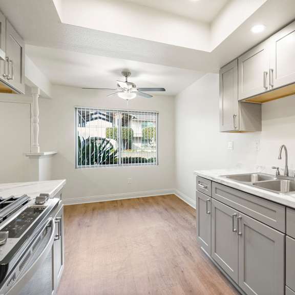 a kitchen with a stove top oven and a marble counter top.