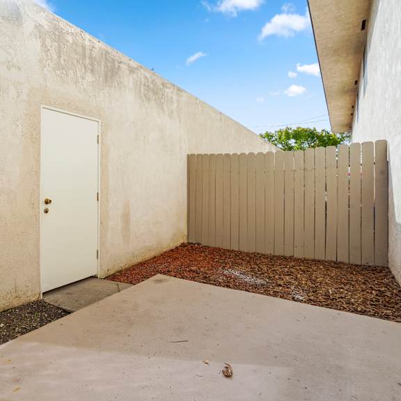 a white door is closed in a concrete room.
