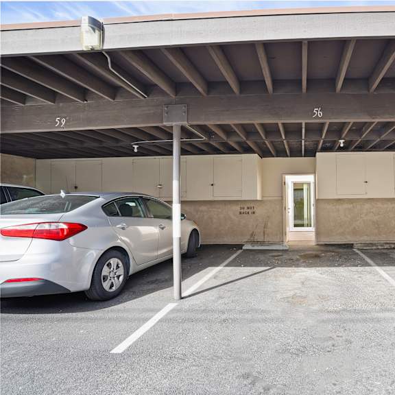 a car is parked in a parking garage with a door marked "exit".