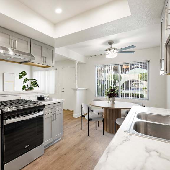 a modern kitchen with a stainless steel oven and a marble countertop.