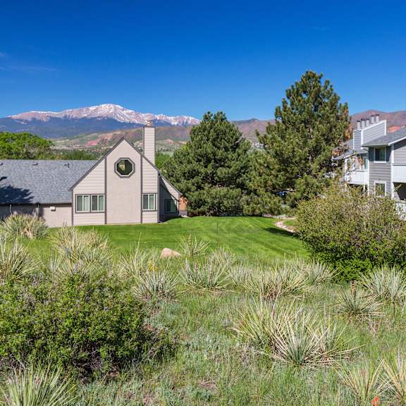a house with a mountain in the background.