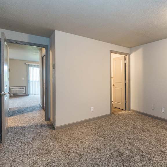 a room with a carpeted floor and a door.