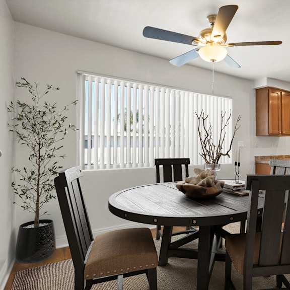 a dining room with a round table and chairs.