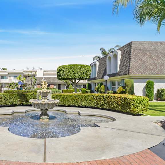 a fountain in the middle of a circular garden.