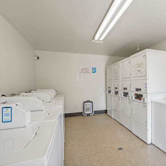 a laundry room with washers and dryers.