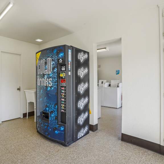 a vending machine in a room with a white wall.