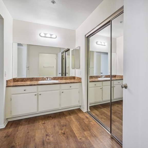 a bathroom with a vanity and a mirror.