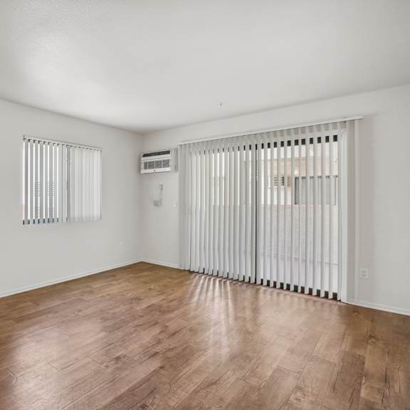 a room with wooden floors and white walls.