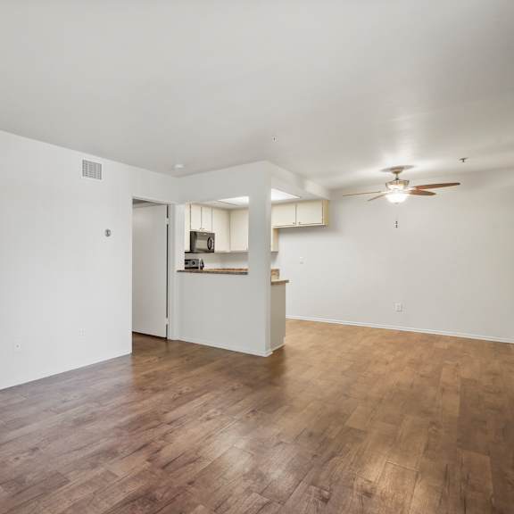 a room with wooden floors and a ceiling fan.