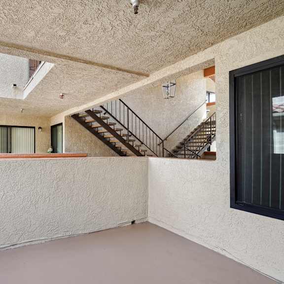 a room with a staircase and a window.