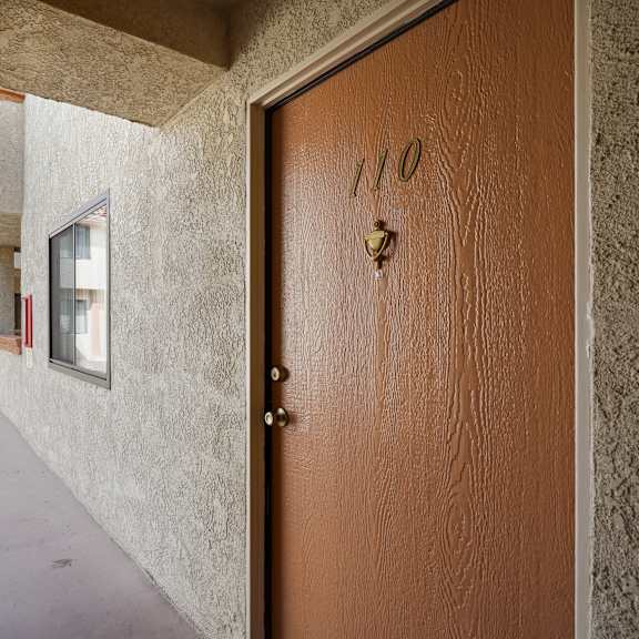 a brown door with the number 110 on it.