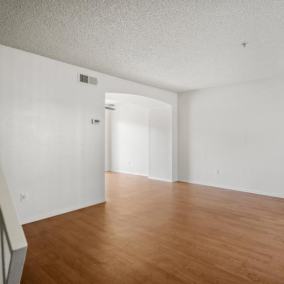 empty room with wooden floor and white walls.