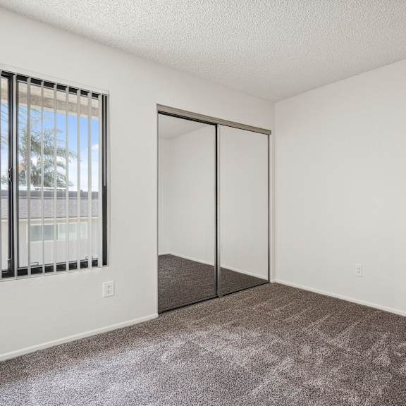 a room with a carpeted floor and a sliding door.