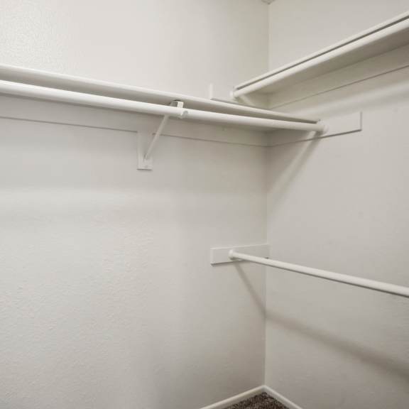 a white wall with a white shelf and white railings.