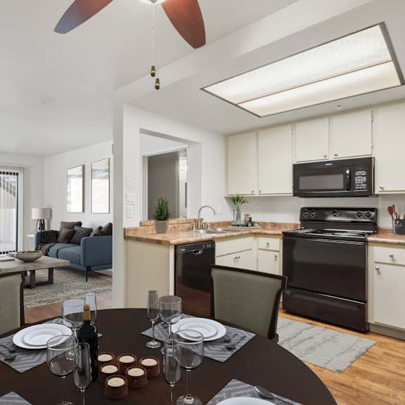 a modern kitchen with a dining table set for two.